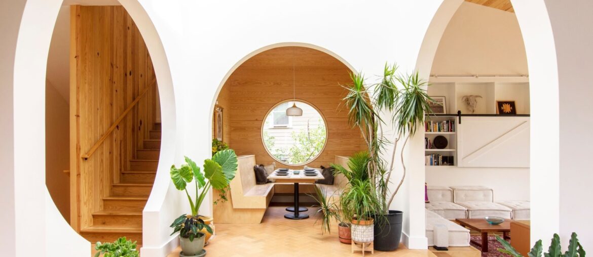 Central atrium connected to multiple arched entrances and a breakfast nook in an Asheville home, Buncombe County, North Carolina [2000x1333]