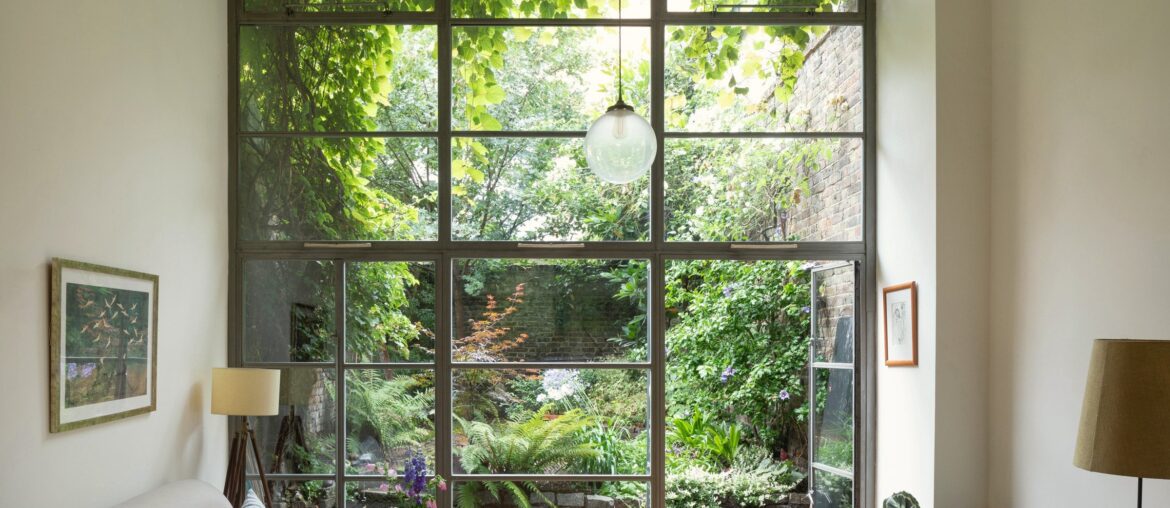 Double-height living space with floor-to-ceiling windows framing the garden, Hackney, East London, UK [2400x1600]