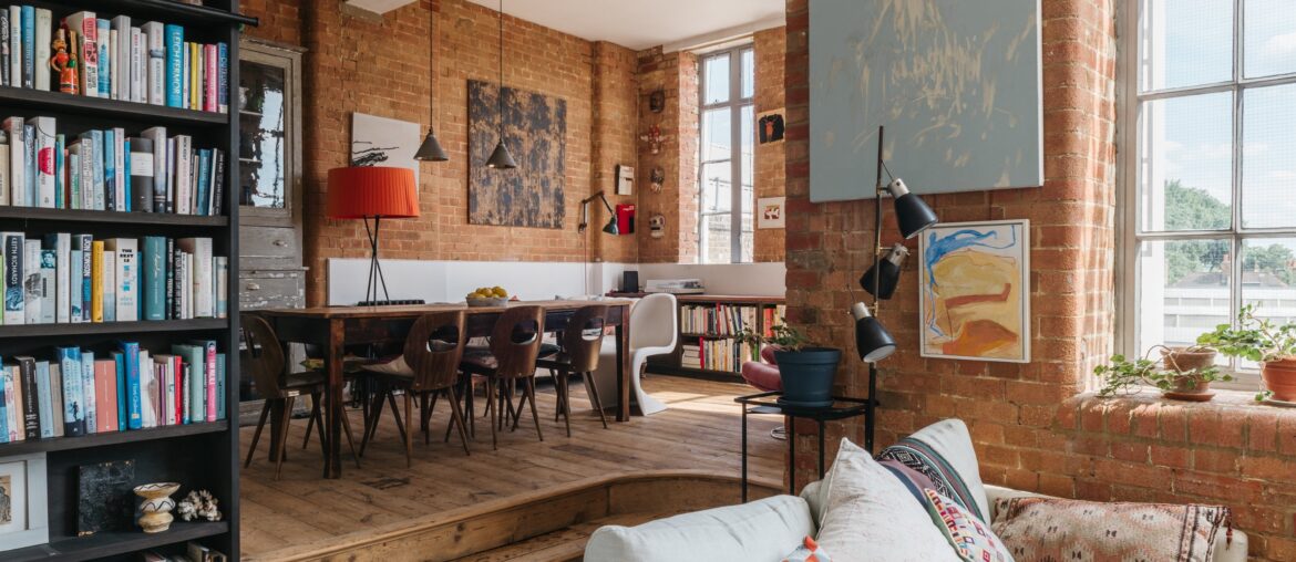 Living space with exposed brickwork in a 1930s former factory building converted one-bedroom apartment, Islington, London, UK [3011x2004]