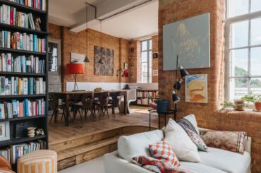 Living space with exposed brickwork in a 1930s former factory building converted one-bedroom apartment, Islington, London, UK [3011x2004]