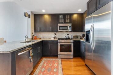 Buying a condo and I hate the kitchen. It looks dated and too dark to me but I'm curious what others think. Not sure if it's worth the massive expense to redo the cabinets and countertop.