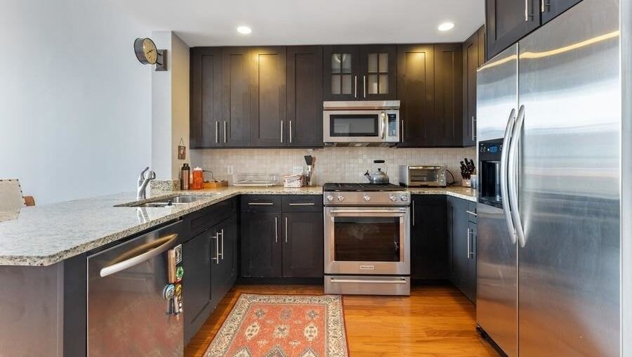 Buying a condo and I hate the kitchen. It looks dated and too dark to me but I'm curious what others think. Not sure if it's worth the massive expense to redo the cabinets and countertop.