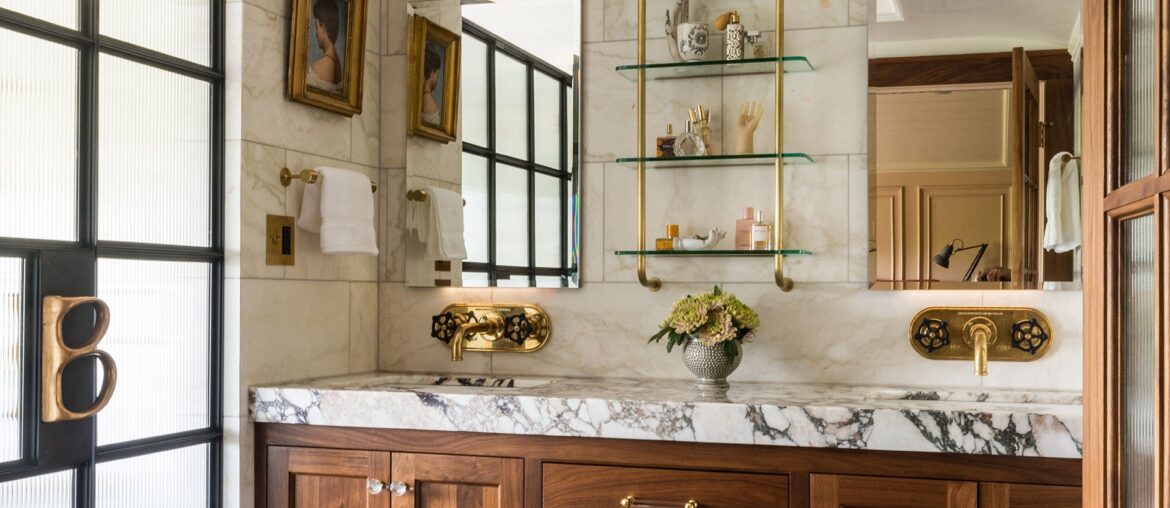 Marble-clad bathroom with a wood vanity in a renovated historic hillside home, Capitol Hill, Seattle, Washington [2002x3000]