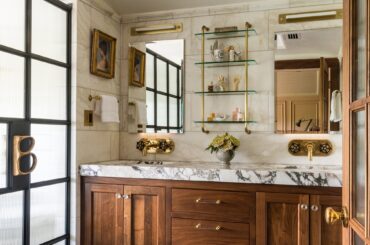 Marble-clad bathroom with a wood vanity in a renovated historic hillside home, Capitol Hill, Seattle, Washington [2002x3000]