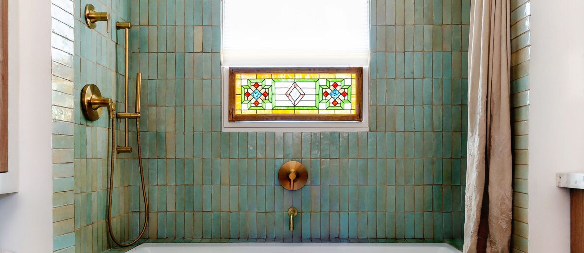 Tiled shower alcove with a stained-glass window in the renovated bathroom of a 1949 ranch-style home, Eagle Rock, Northeast Los Angeles [3153x3941]