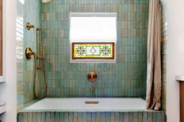 Tiled shower alcove with a stained-glass window in the renovated bathroom of a 1949 ranch-style home, Eagle Rock, Northeast Los Angeles [3153x3941]
