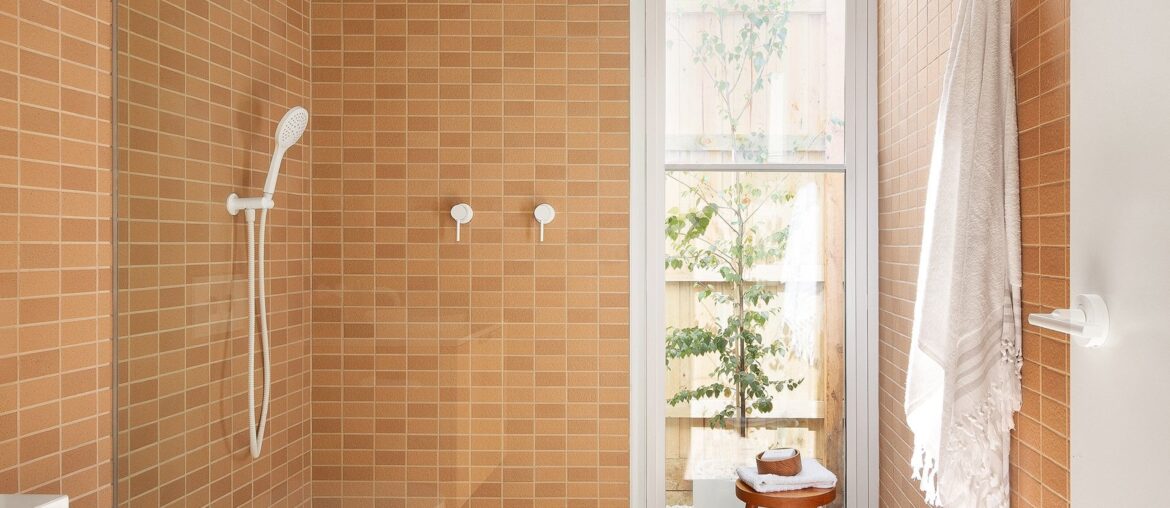 Tiled bathroom with a full-height glazed window in a renovated home, Northcote, Melbourne, Victoria, Australia [1920x2880]