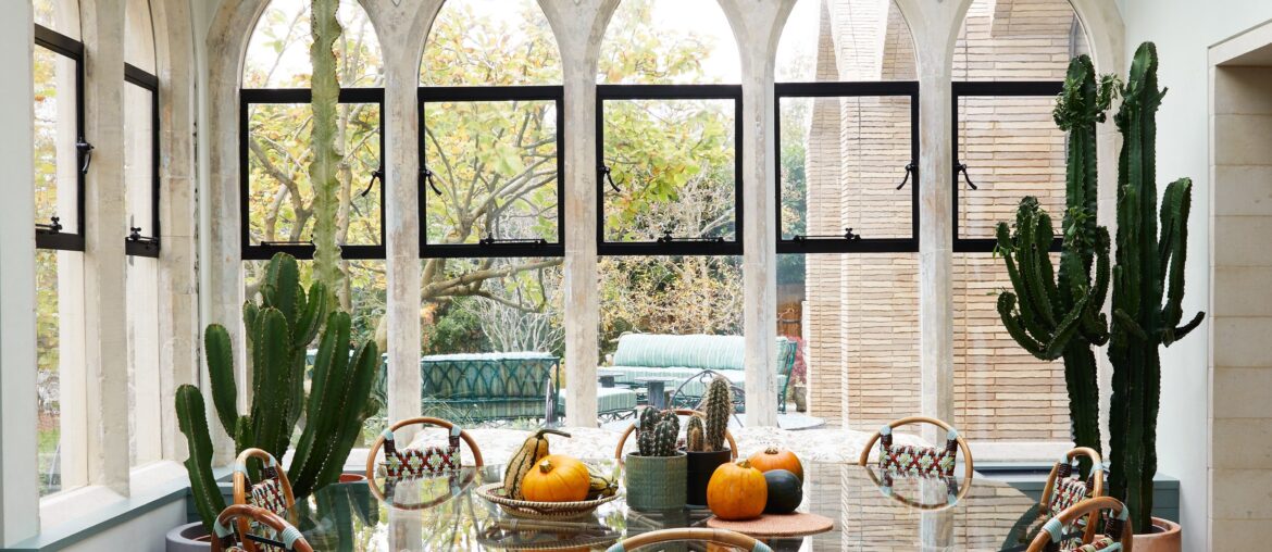 Conservatory with several skinny windows topped with gothic arches in a restored and renovated 1879 gothic revival house, Highgate, North London, UK [3820x5000]