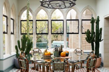 Conservatory with several skinny windows topped with gothic arches in a restored and renovated 1879 gothic revival house, Highgate, North London, UK [3820x5000]