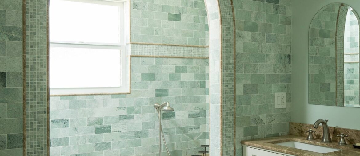 Arched shower alcove in a marble tile-clad bathroom, Los Angeles [1706x2560]