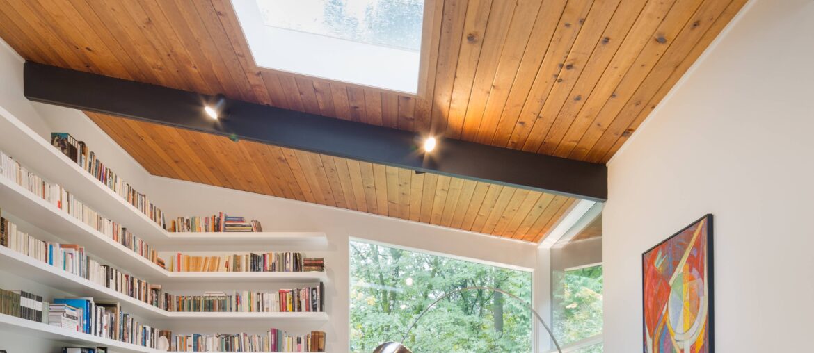 Tall living space lined with bookshelves under a skylight in a renovated Mid-century modern residence, Portland, Oregon [3840x5760]