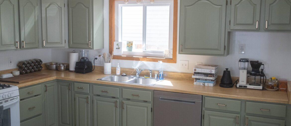 Painted cabinets and put in a new light fixture. Looking for input on what to do with window trim and countertops. Any feedback appreciated!