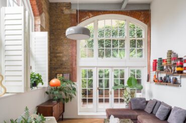 Apartment with arched mullion windows and exposed brick walls in a converted Victorian school building, Tower Hamlets, London, UK [2400x1600]