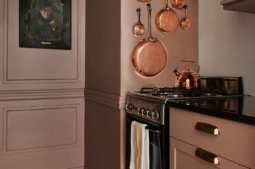 Small galley kitchen painted in a muted rose color in a West Village apartment, Lower Manhattan, New York City [1200x1500]
