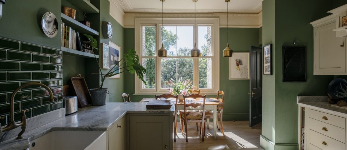 Green kitchen and dining space in a renovated Victorian townhouse, Clapham, Lambeth, southwest London, UK [2400x1600]