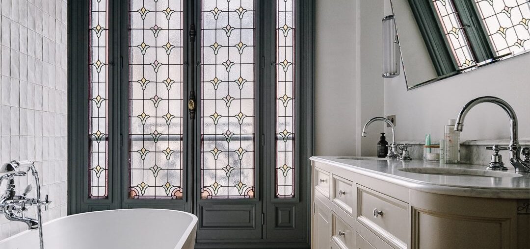 Bathroom with a stained glass window in an ornate 1920s apartment in the 17th arrondissement of Paris, France [1080x1350]