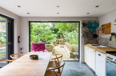 Garden views framed with a large window in the kitchen of a two-bedroom garden flat near Finsbury Park, North London, UK [2400x1600]