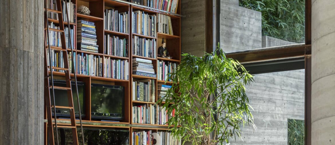 Double-height living space with a tall bookshelf in a West Hollywood modernist residence, Los Angeles County, California [3333x5000]
