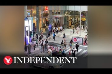 Crowds rush out of busy Bangkok mall amid reports of deadly shooting