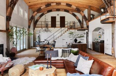 Spacious open plan living space with curved beams in a barn-inspired vacation home, Washington [1600x1200]