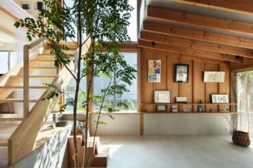 Japanese architect Kohei Yukawa has designed a house for himself and his family in a suburb of Osaka, featuring flexible living spaces arranged around a double-height atrium with a tree at its centre. [2364x1330]