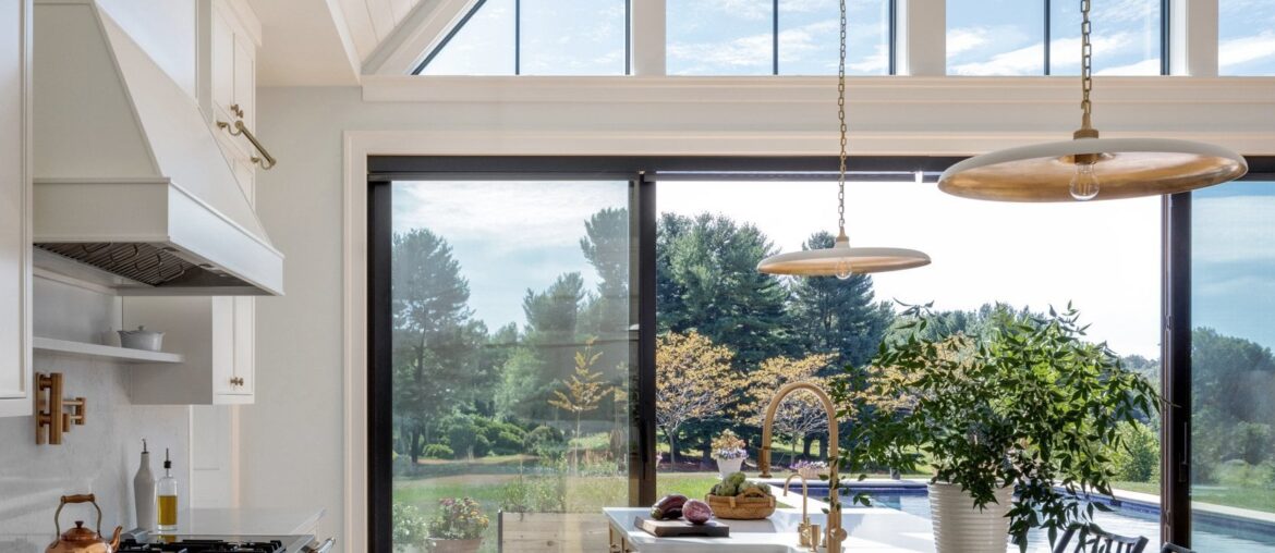Tall vaulted ceiling kitchen and dining opening up to the pool in a residence near Baltimore, Maryland [1667x2500]