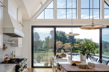 Tall vaulted ceiling kitchen and dining opening up to the pool in a residence near Baltimore, Maryland [1667x2500]