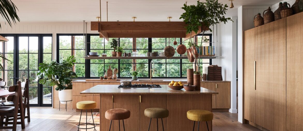 Kitchen with white oak cabinets and a custom stainless steel rack in a renovated Montauk residence, Long Island, New York [2000x1334]