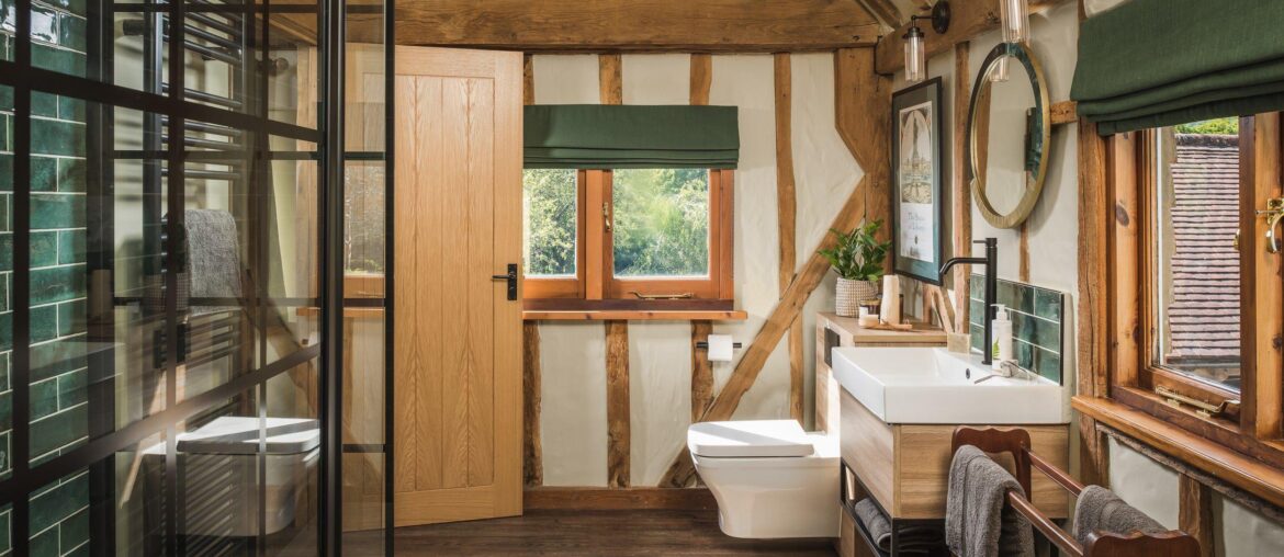 Bathroom with exposed beams in an 18th-century farmhouse converted into a holiday home, Kent, South East England [2500x1668]