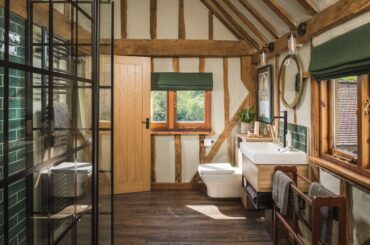 Bathroom with exposed beams in an 18th-century farmhouse converted into a holiday home, Kent, South East England [2500x1668]