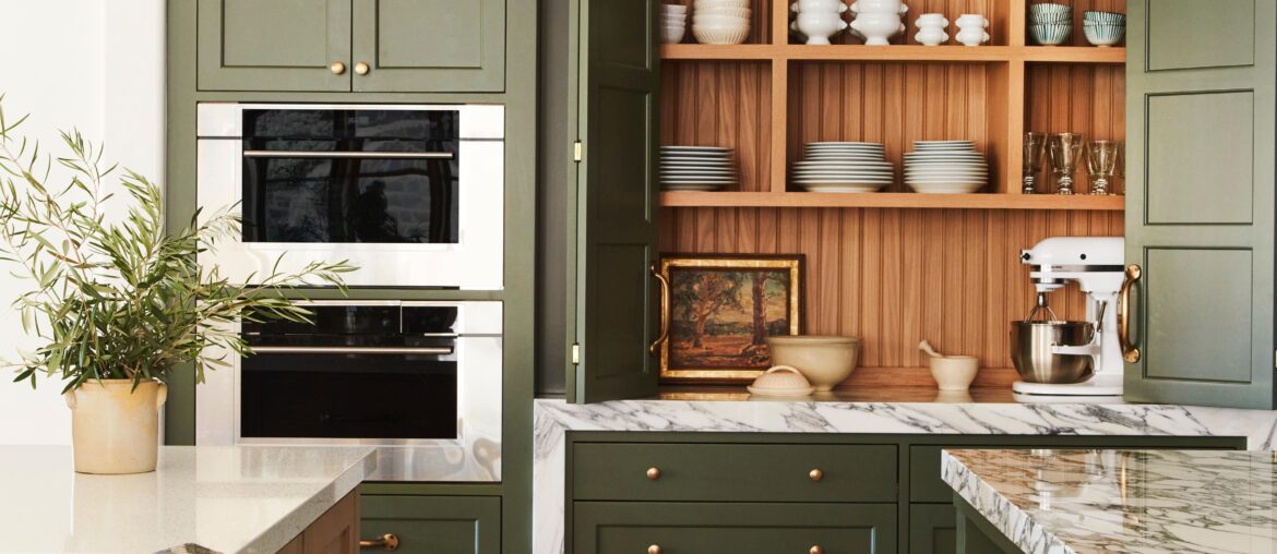 Green kitchen cabinetry with bi-fold doors in a renovated Spanish Colonial residence in the Santa Monica Mountains, Southern California [4800x7237]