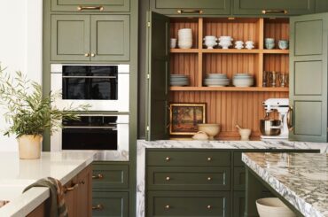 Green kitchen cabinetry with bi-fold doors in a renovated Spanish Colonial residence in the Santa Monica Mountains, Southern California [4800x7237]