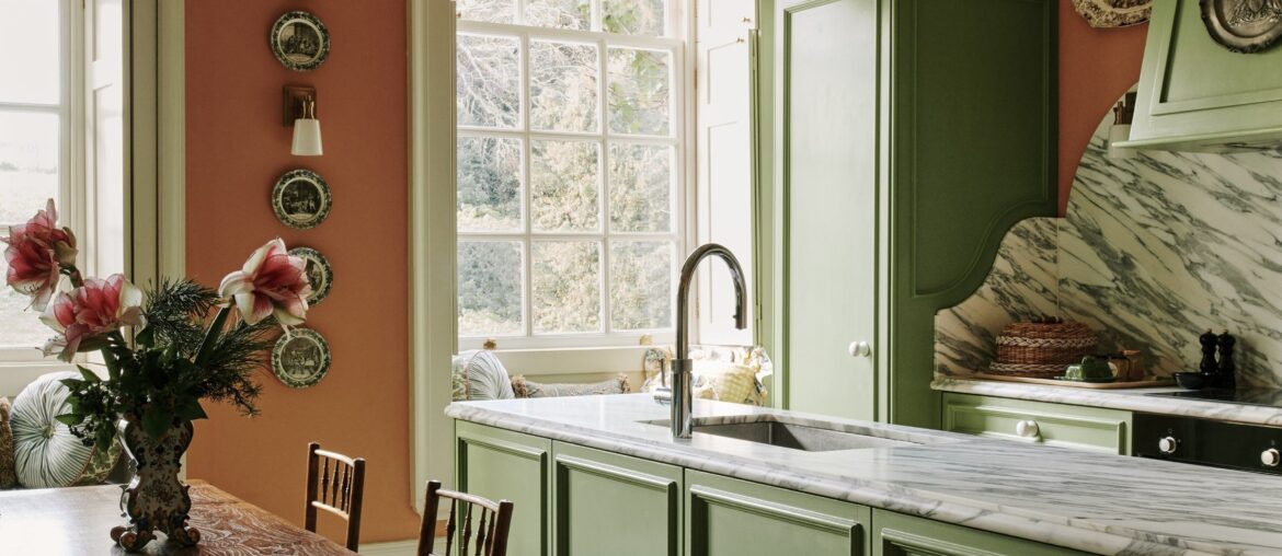Tall kitchen with veined white marble backsplash in a 17th-century country house now split into seven flats near Chichester, West Sussex, England [2316x3000]