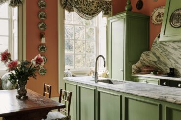 Tall kitchen with veined white marble backsplash in a 17th-century country house now split into seven flats near Chichester, West Sussex, England [2316x3000]