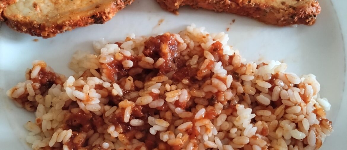 Lomo adobado with rice and black garlic tomato sauce