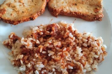 Lomo adobado with rice and black garlic tomato sauce