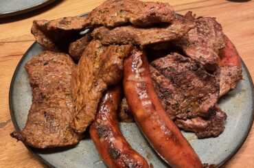 Steak and Käsekrainer grilled outdoors