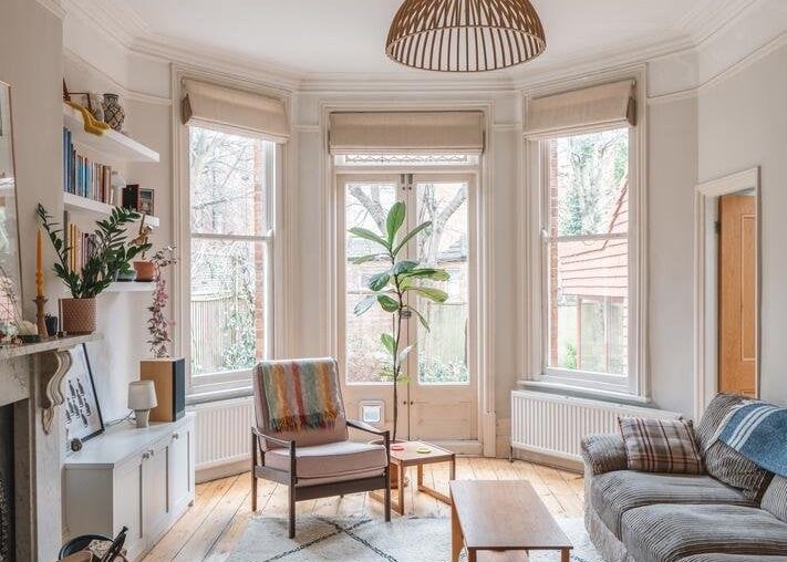 Living room with French doors opening up to the garden in a Victorian villa with a modern kitchen and dining extension, Willesden Green, northwest London, UK [711x1067]