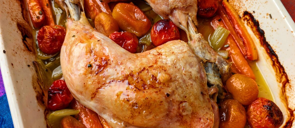 Chicken with carrots, celery, cherry tomatoes and kumquats. Seasoned with salt and rosemary.