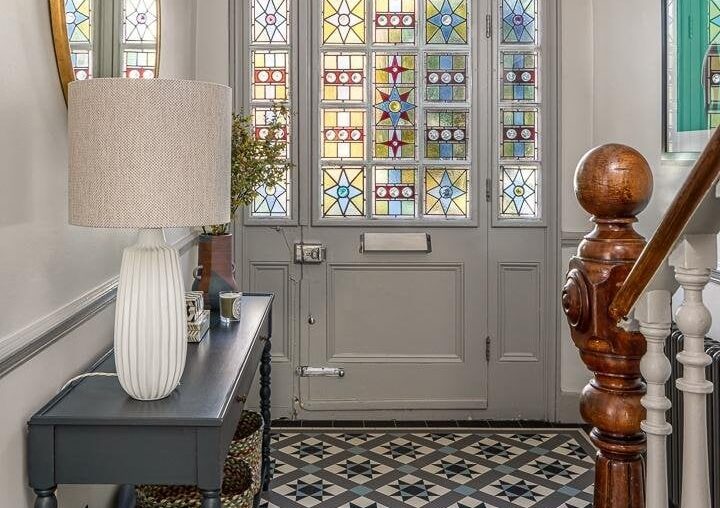 Colorful patterned tile floor entrance with a stained glass front door in a period home that received a contemporary update, Wandsworth Common, Wandsworth, south London, UK [720x1080]