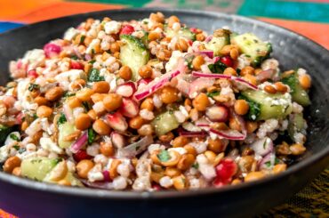 Lentil salad with pearl barley, cucumber, pomegranate seeds, red onion, feta cheese, balsamico bianco, salt, flat parsley and thyme.