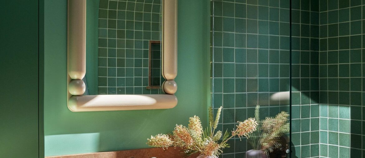 Teal bathroom with a tile-clad arched bathtub nook in a renovated 1920s hilltop house in Mount Washington full of vibrant colors, Los Angeles [2500x3333]