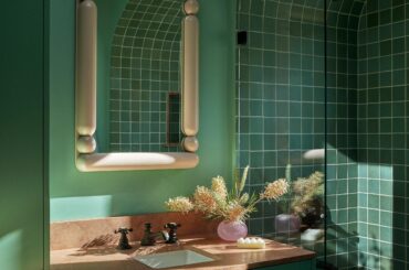 Teal bathroom with a tile-clad arched bathtub nook in a renovated 1920s hilltop house in Mount Washington full of vibrant colors, Los Angeles [2500x3333]