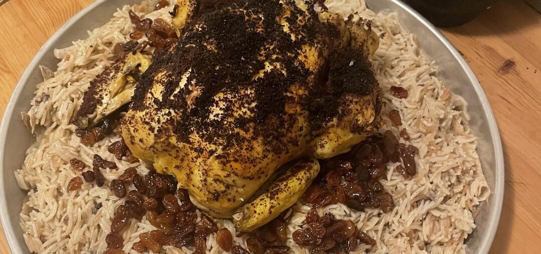 Gazan-style stuffed roast chicken with sumac over seasoned rice with raisins