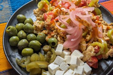 Today's breakfast. The usual scrambled eggs but now with pickled onions and jalapeños plus feta cheese and olives.