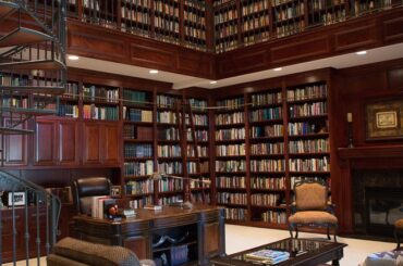 Double-height home office library with a fire place [660x990]