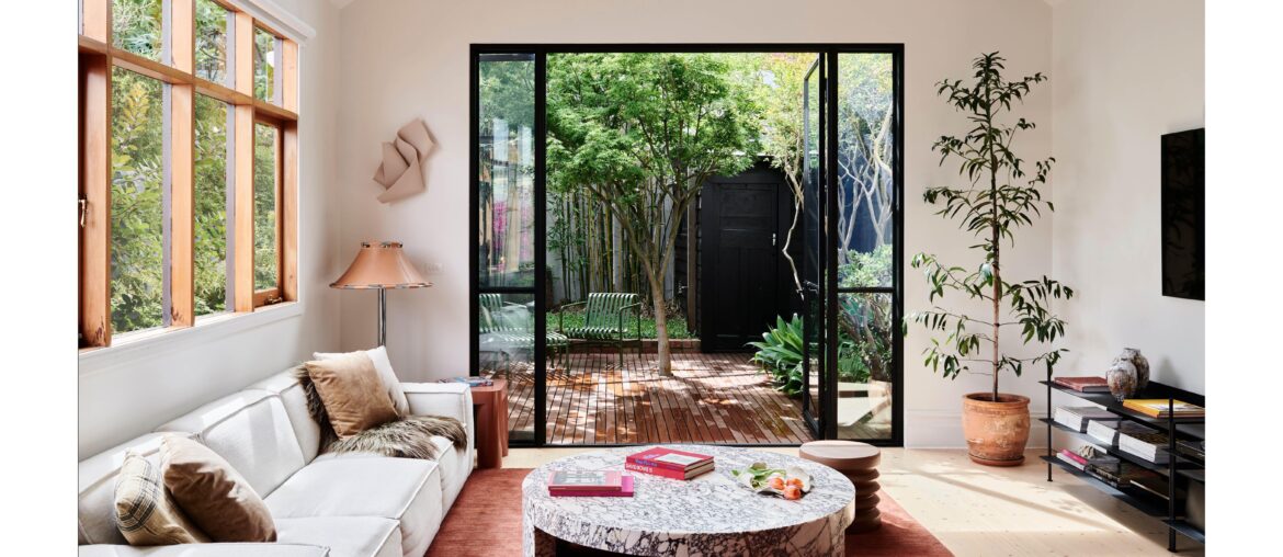 Living space with steel framed doors opening up to the garden in a renovated Victorian terrace, Northcote, Melbourne, Australia [6250x3515]