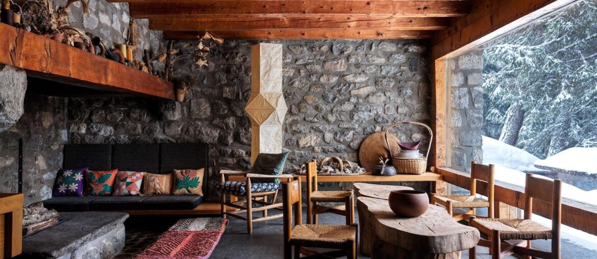 Exposed stone wall living room with a stone hearth in a ski chalet in Méribel, a ski resort in the Tarentaise Valley in the French Alps, Savoie, France [2500x1874]
