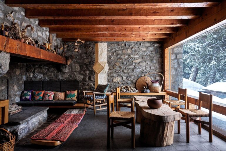 Exposed stone wall living room with a stone hearth in a ski chalet in Méribel, a ski resort in the Tarentaise Valley in the French Alps, Savoie, France [2500x1874]
