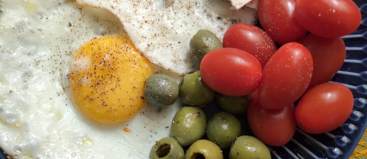Fried eggs with olives, tomatoes and feta.